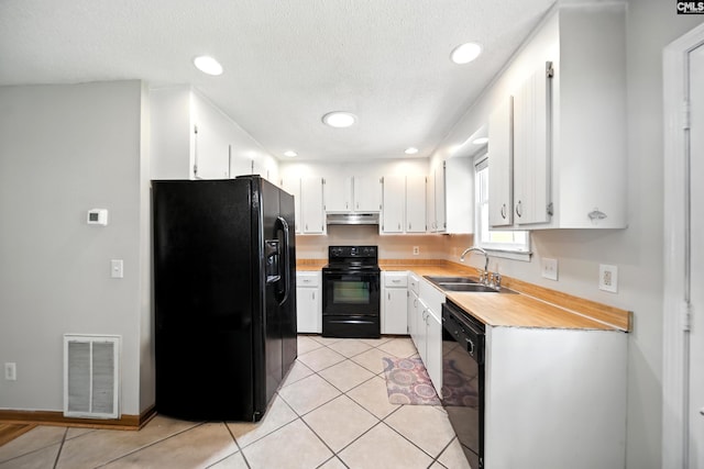 224 Ashton Cir, Lexington, SC 29073 - kitchen with black appliances, light countertops, under cabinet range hood, white cabinets, and light tile patterned floors