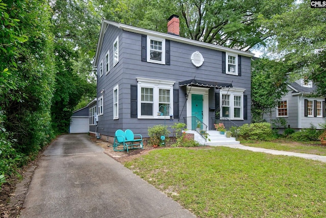 2817 Duncan St, Columbia, SC 29205 - view of front of property with a chimney, a front yard, an outbuilding, and a detached garage