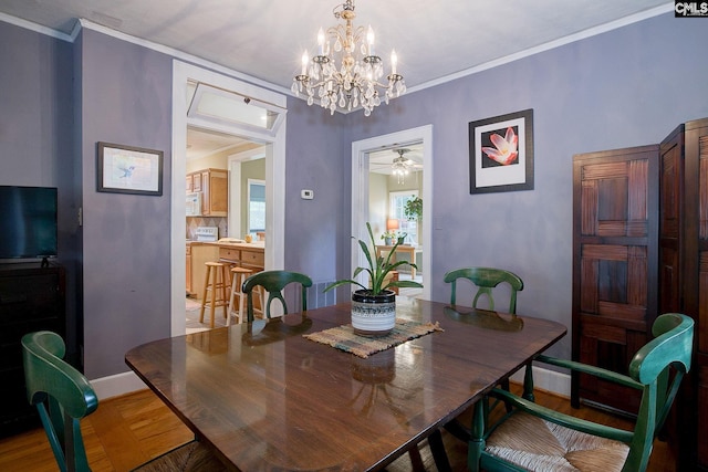 2817 Duncan St, Columbia, SC 29205 - dining room featuring light wood-type flooring, a chandelier, crown molding, and ceiling fan