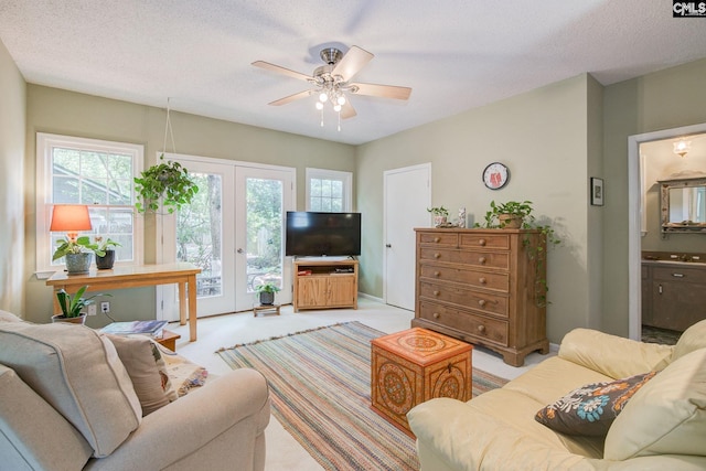 2817 Duncan St, Columbia, SC 29205 - living room with french doors, ceiling fan, plenty of natural light, light carpet, and a textured ceiling