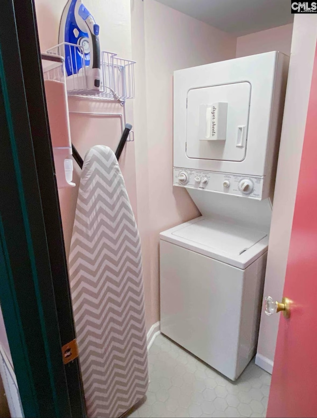 2009 Greene St Unit 403, Columbia, SC 29205 - laundry area featuring stacked washer / dryer and baseboards