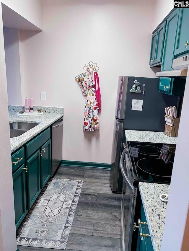 2009 Greene St Unit 403, Columbia, SC 29205 - kitchen with electric range oven, stainless steel dishwasher, under cabinet range hood, dark wood-type flooring, and light stone counters