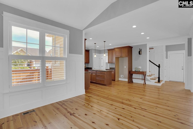 100 Julia Ct, Lexington, SC 29072 - unfurnished living room featuring a decorative wall, light wood-style flooring, stairway, vaulted ceiling, and ornamental molding
