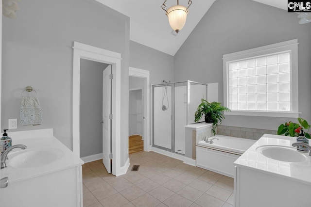 100 Julia Ct, Lexington, SC 29072 - bathroom featuring a stall shower, two vanities, a bath, vaulted ceiling, and tile patterned floors