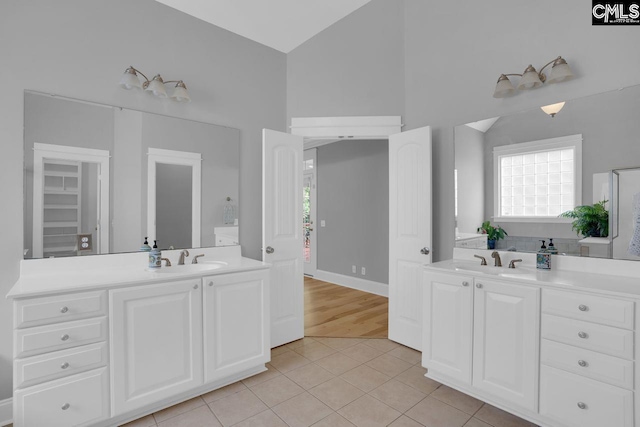 100 Julia Ct, Lexington, SC 29072 - full bathroom featuring tile patterned floors, two vanities, and high vaulted ceiling