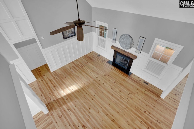 100 Julia Ct, Lexington, SC 29072 - unfurnished living room featuring a fireplace, light wood-type flooring, ceiling fan, a decorative wall, and a wainscoted wall