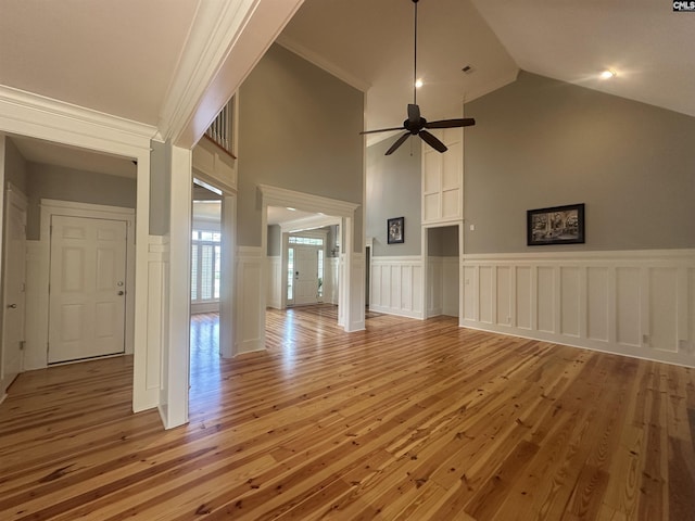 100 Julia Ct, Lexington, SC 29072 - unfurnished living room with light wood finished floors, ceiling fan, wainscoting, a decorative wall, and high vaulted ceiling