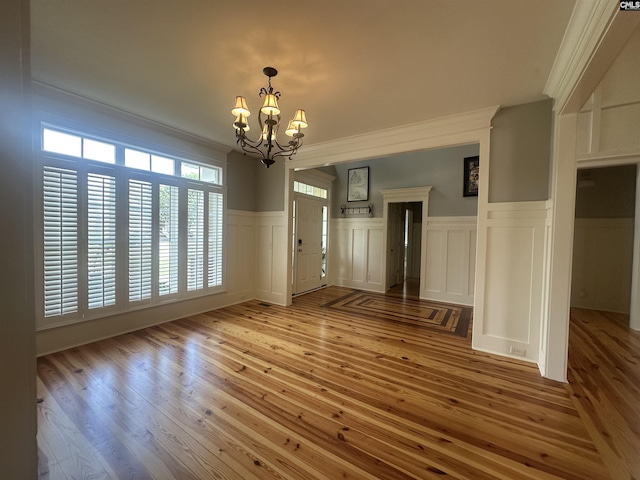 100 Julia Ct, Lexington, SC 29072 - unfurnished dining area with a chandelier, a decorative wall, hardwood / wood-style floors, wainscoting, and crown molding