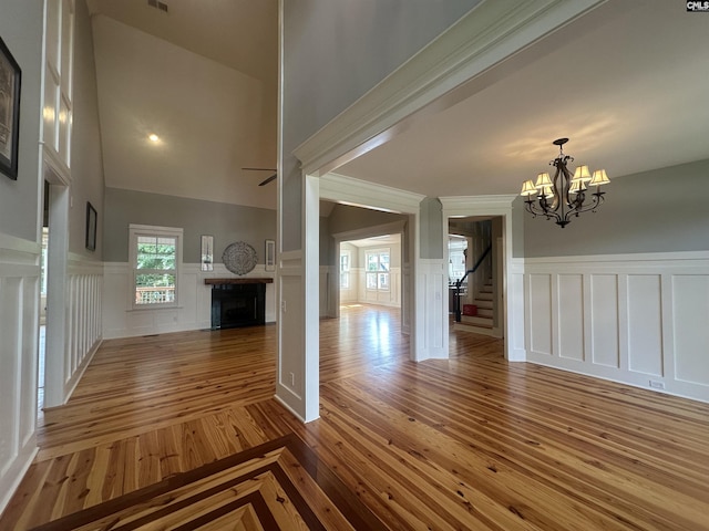 100 Julia Ct, Lexington, SC 29072 - unfurnished living room with a decorative wall, a chandelier, a fireplace, wainscoting, and stairway