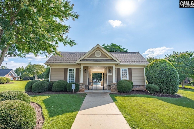 100 Julia Ct, Lexington, SC 29072 - view of front facade featuring a front lawn, a shingled roof, and stone siding