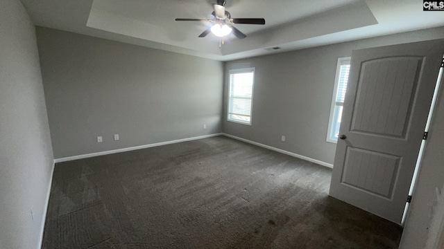 1020 Winter Way, Lexington, SC 29073 - empty room featuring a raised ceiling, dark carpet, and ceiling fan