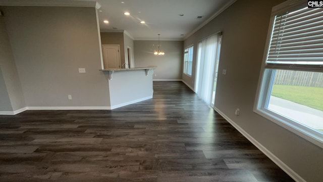 1020 Winter Way, Lexington, SC 29073 - unfurnished living room with a chandelier, crown molding, dark wood-type flooring, and recessed lighting