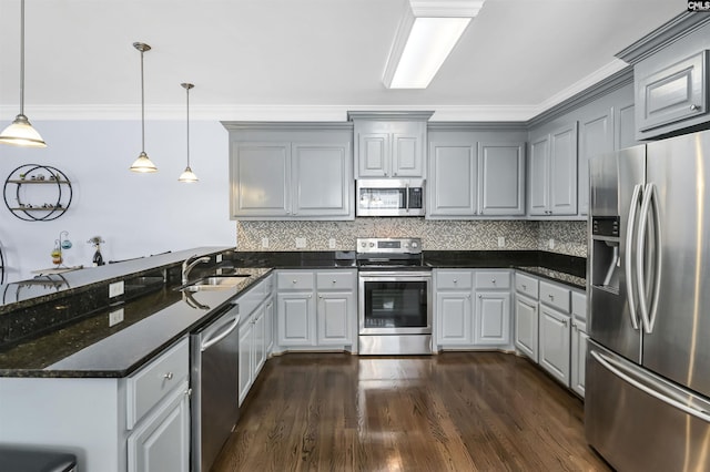 3722 Heyward St, Columbia, SC 29205 - kitchen featuring appliances with stainless steel finishes, a peninsula, gray cabinets, backsplash, and crown molding