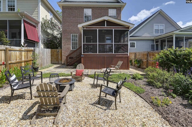 3722 Heyward St, Columbia, SC 29205 - back of property with a sunroom, an outdoor fire pit, and brick siding