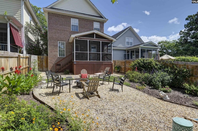 3722 Heyward St, Columbia, SC 29205 - back of property with a sunroom, brick siding, a fire pit, and a fenced backyard