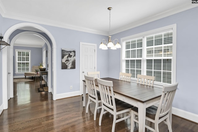 3722 Heyward St, Columbia, SC 29205 - dining area with a chandelier, crown molding, dark wood finished floors, and arched walkways