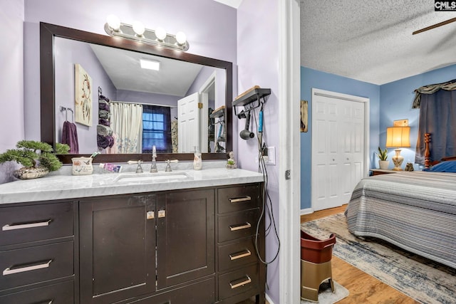 3204 Windmill Rd, Leesville, SC 29070 - ensuite bathroom with vanity, wood finished floors, a ceiling fan, and a textured ceiling