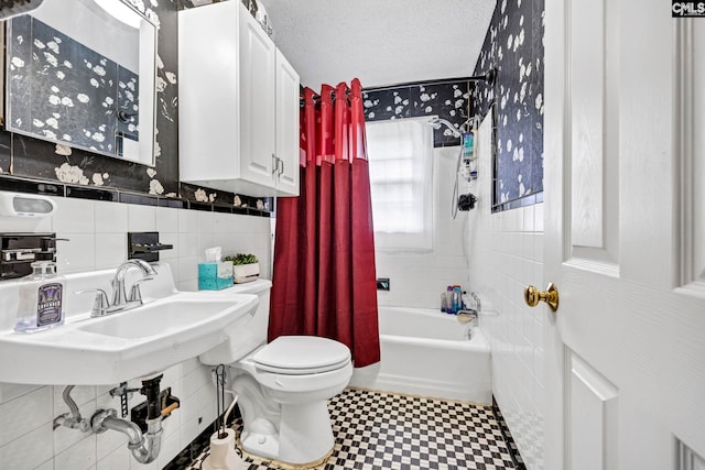 3204 Windmill Rd, Leesville, SC 29070 - bathroom with tile walls, tile patterned floors, shower / tub combo, a wainscoted wall, and a textured ceiling