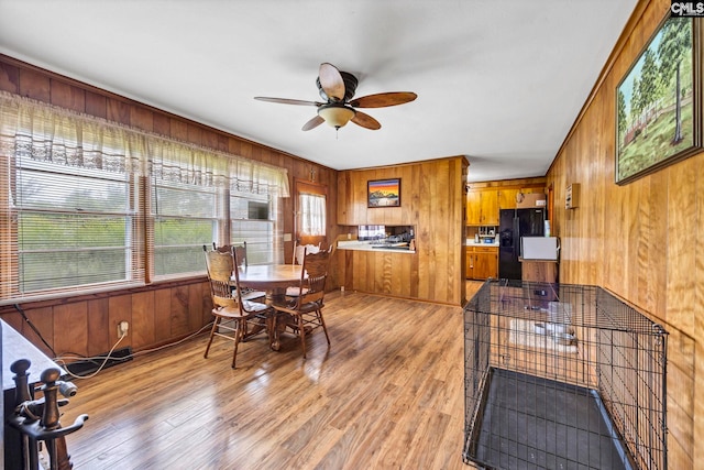3204 Windmill Rd, Leesville, SC 29070 - dining space with wooden walls, ceiling fan, and light wood finished floors