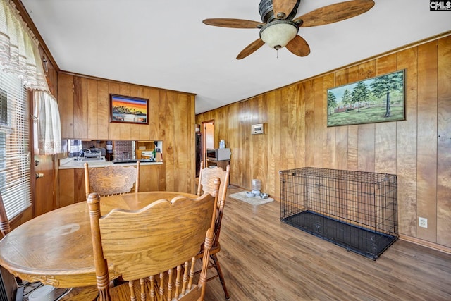 3204 Windmill Rd, Leesville, SC 29070 - dining area featuring wood walls, wood finished floors, and a ceiling fan