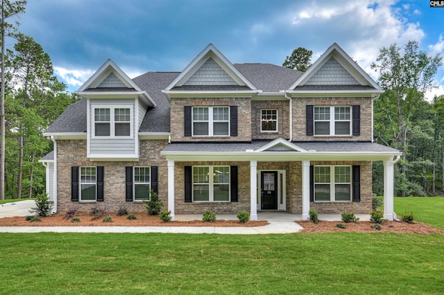 20 Belfast Ct, North Augusta, SC 29860 - craftsman house featuring roof with shingles, a front yard, brick siding, and covered porch