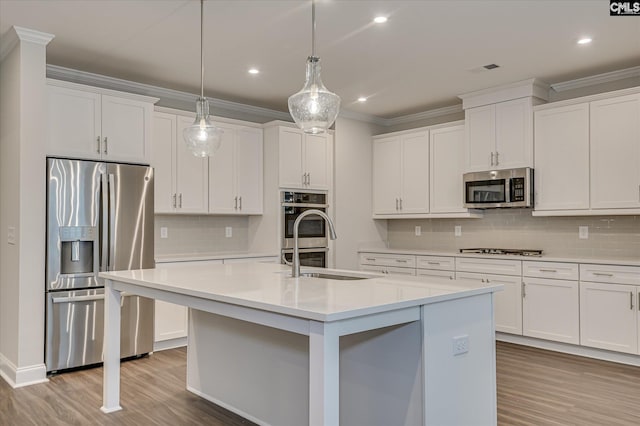 20 Belfast Ct, North Augusta, SC 29860 - kitchen featuring appliances with stainless steel finishes, wood finished floors, backsplash, light countertops, and crown molding