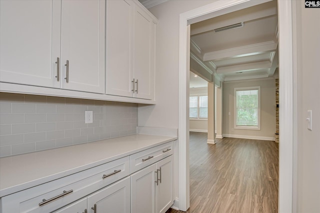 20 Belfast Ct, North Augusta, SC 29860 - kitchen with ornamental molding, light countertops, decorative backsplash, white cabinetry, and light wood-style flooring