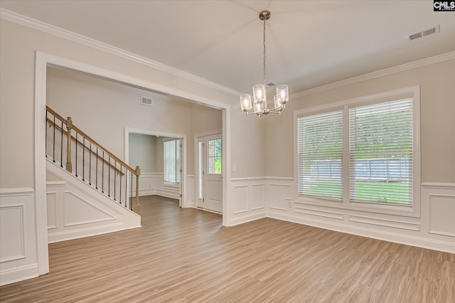 20 Belfast Ct, North Augusta, SC 29860 - spare room with a chandelier, a decorative wall, stairway, crown molding, and wood finished floors