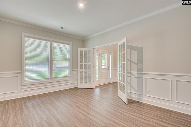 20 Belfast Ct, North Augusta, SC 29860 - unfurnished room with french doors, a decorative wall, crown molding, wainscoting, and light wood-style floors