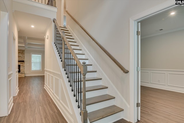 20 Belfast Ct, North Augusta, SC 29860 - staircase featuring wood finished floors, crown molding, a decorative wall, a wainscoted wall, and recessed lighting