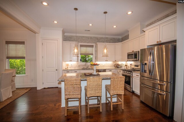 221 Coldwater Xing, Lexington, SC 29072 - kitchen featuring appliances with stainless steel finishes, white cabinetry, light stone countertops, recessed lighting, and ornamental molding