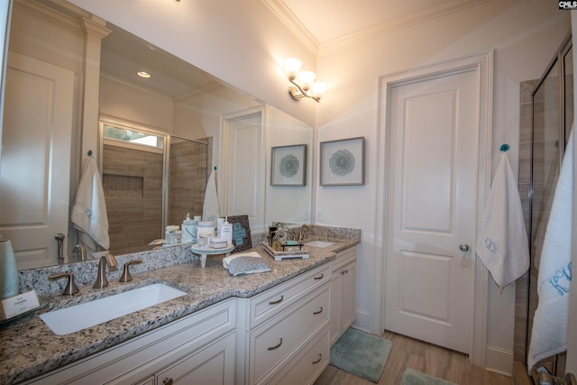 221 Coldwater Xing, Lexington, SC 29072 - bathroom featuring a stall shower, crown molding, double vanity, and wood finished floors