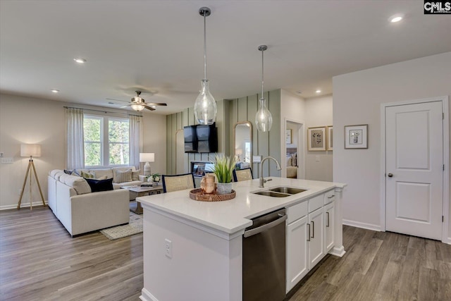 182 Scruple Way, North Augusta, SC 29860 - kitchen with stainless steel dishwasher, open floor plan, wood finished floors, white cabinets, and a kitchen island with sink