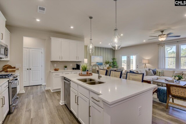 182 Scruple Way, North Augusta, SC 29860 - kitchen with stainless steel appliances, light countertops, open floor plan, light wood-type flooring, and recessed lighting