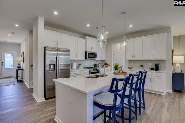 182 Scruple Way, North Augusta, SC 29860 - kitchen with stainless steel appliances, light wood finished floors, white cabinets, and recessed lighting