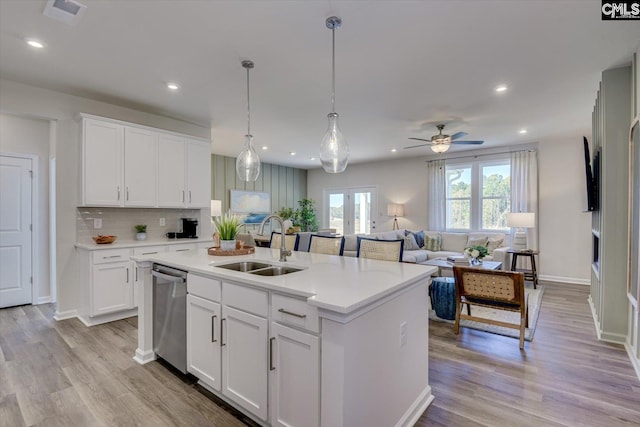 182 Scruple Way, North Augusta, SC 29860 - kitchen with dishwasher, light countertops, a center island with sink, open floor plan, and light wood-type flooring