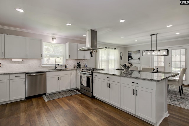 1601 Hagood Ave, Columbia, SC 29204 - kitchen featuring stainless steel appliances, island range hood, a peninsula, ornamental molding, and dark wood-type flooring