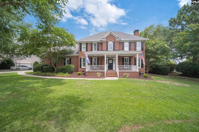 100 Morning Echo Dr, Columbia, SC 29229 - view of front facade with covered porch, brick siding, a chimney, and a front yard