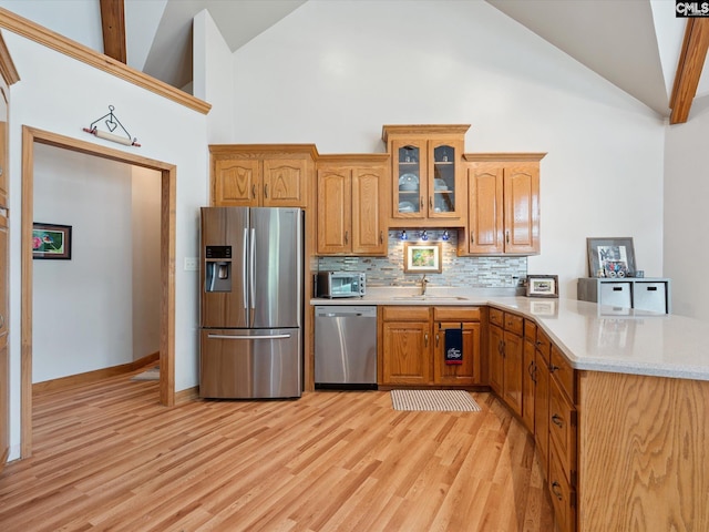 887 Living Waters, Great Falls, SC 29055 - kitchen featuring stainless steel appliances, high vaulted ceiling, backsplash, a peninsula, and glass insert cabinets