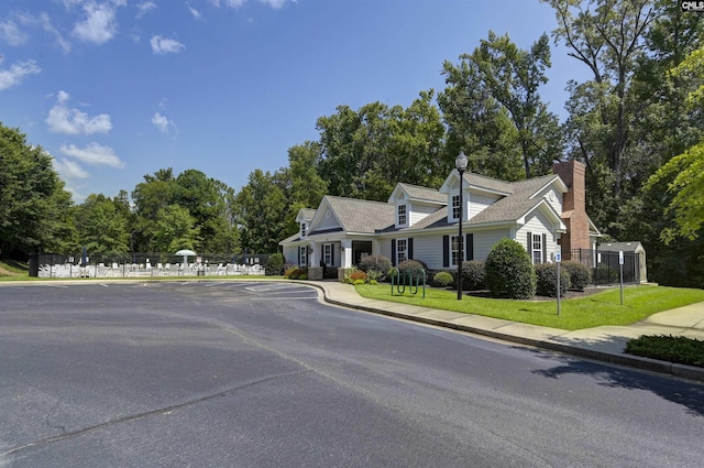 821 Burnview Ln, Chapin, SC 29036 - cape cod-style house with view of wooded area and a chimney