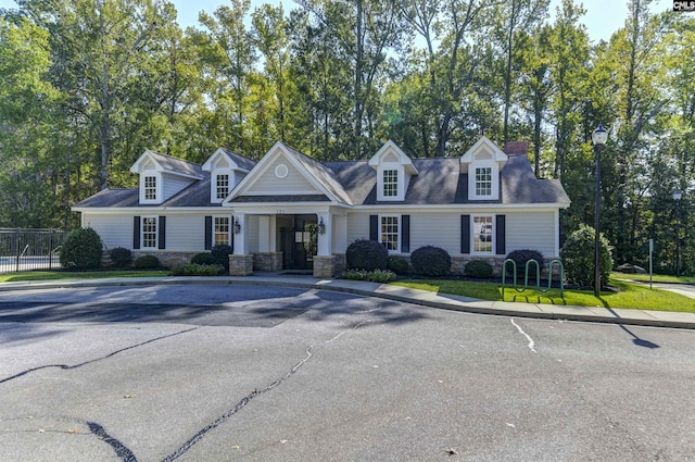 821 Burnview Ln, Chapin, SC 29036 - cape cod house featuring stone siding, a chimney, and covered porch