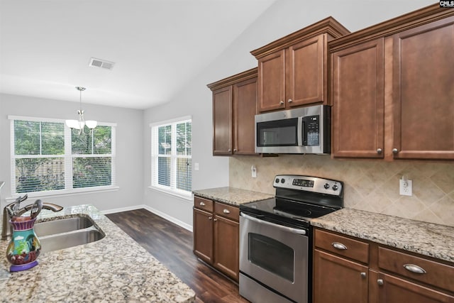 821 Burnview Ln, Chapin, SC 29036 - kitchen with stainless steel appliances, backsplash, dark wood-type flooring, lofted ceiling, and light stone counters