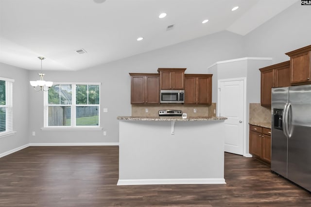821 Burnview Ln, Chapin, SC 29036 - kitchen with stainless steel appliances, a chandelier, light stone countertops, tasteful backsplash, and lofted ceiling