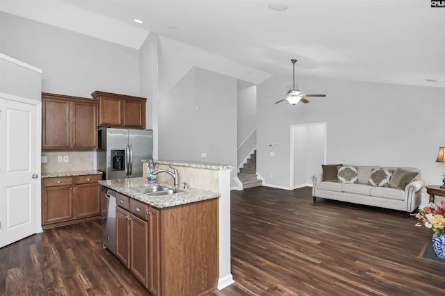 821 Burnview Ln, Chapin, SC 29036 - kitchen featuring stainless steel appliances, open floor plan, high vaulted ceiling, light stone counters, and dark wood-style floors