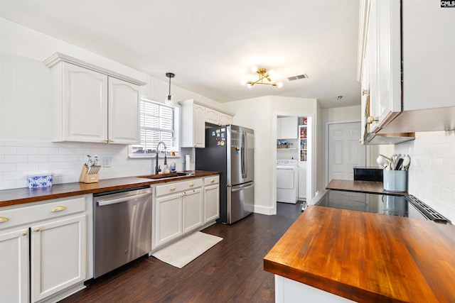 103 Faircrest Way, Columbia, SC 29229 - kitchen featuring butcher block counters, appliances with stainless steel finishes, washer / dryer, decorative backsplash, and dark wood-style flooring
