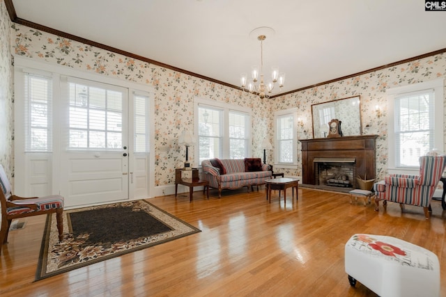 232 Boulware Rd, Lugoff, SC 29078 - living room featuring crown molding, wallpapered walls, a chandelier, healthy amount of natural light, and light wood-style flooring