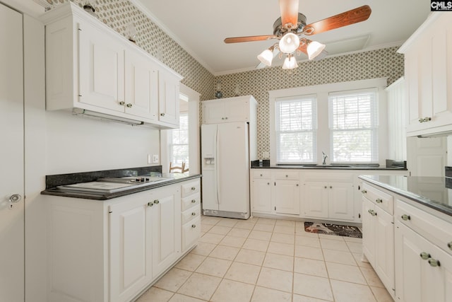 232 Boulware Rd, Lugoff, SC 29078 - kitchen featuring white refrigerator with ice dispenser, crown molding, wallpapered walls, dark countertops, and a ceiling fan