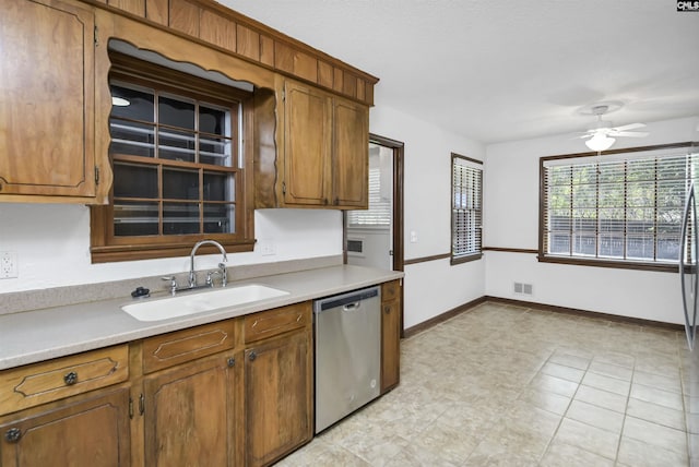 136 Traylors Gate Cir, Irmo, SC 29063 - kitchen featuring stainless steel dishwasher, light countertops, a ceiling fan, and brown cabinetry