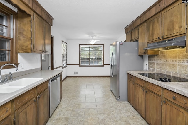 136 Traylors Gate Cir, Irmo, SC 29063 - kitchen featuring under cabinet range hood, stainless steel appliances, backsplash, light countertops, and a ceiling fan
