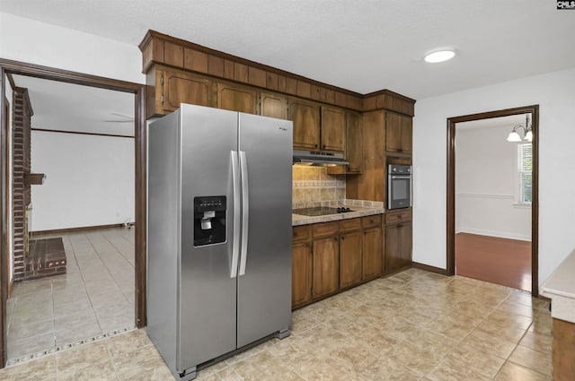 136 Traylors Gate Cir, Irmo, SC 29063 - kitchen featuring appliances with stainless steel finishes, under cabinet range hood, decorative backsplash, light tile patterned floors, and light countertops